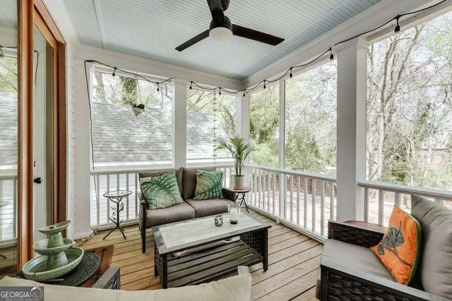 a living room with furniture tv and a window