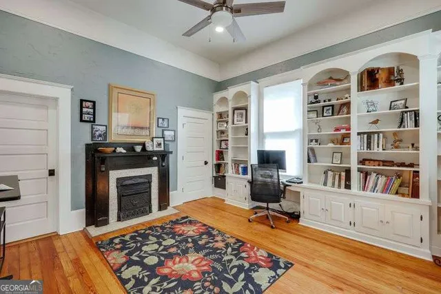 a view of a workspace with furniture and a bookshelf