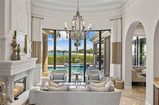 a living room with furniture and a chandelier