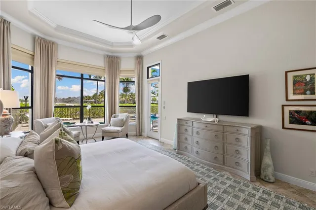 a living room with patio furniture and windows