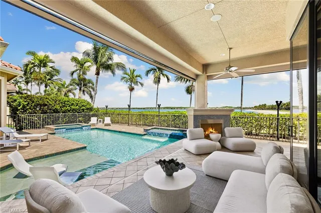 a living room with patio furniture and a garden