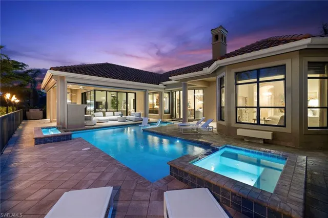 a view of swimming pool with a table and chairs