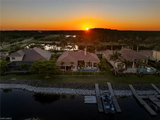 a view of a lake with houses in back