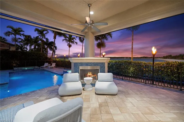 a living room with furniture a fireplace and walls