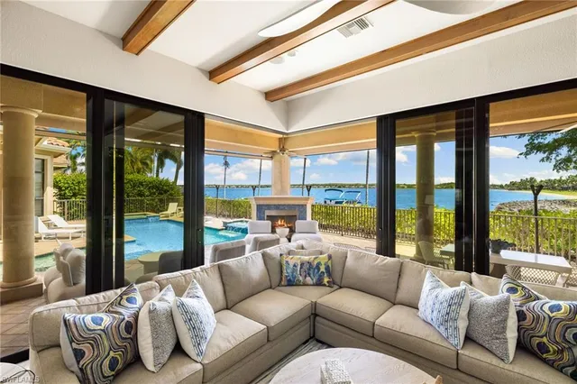 a living room with furniture and floor to ceiling windows