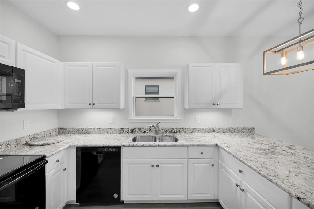 407 Dallas Street Rice, TX 75155 - Photo 12 of 25 a kitchen with granite countertop stainless steel appliances white cabinets granite counter tops and a wooden floors