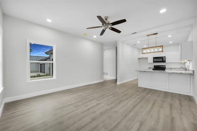 a view of kitchen with sink microwave and stove