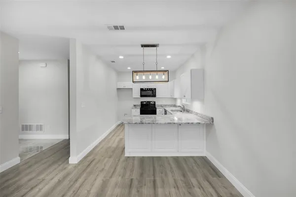 a view of kitchen with sink microwave and refrigerator