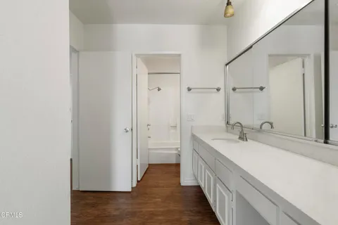 a bathroom with a double vanity sink and a mirror