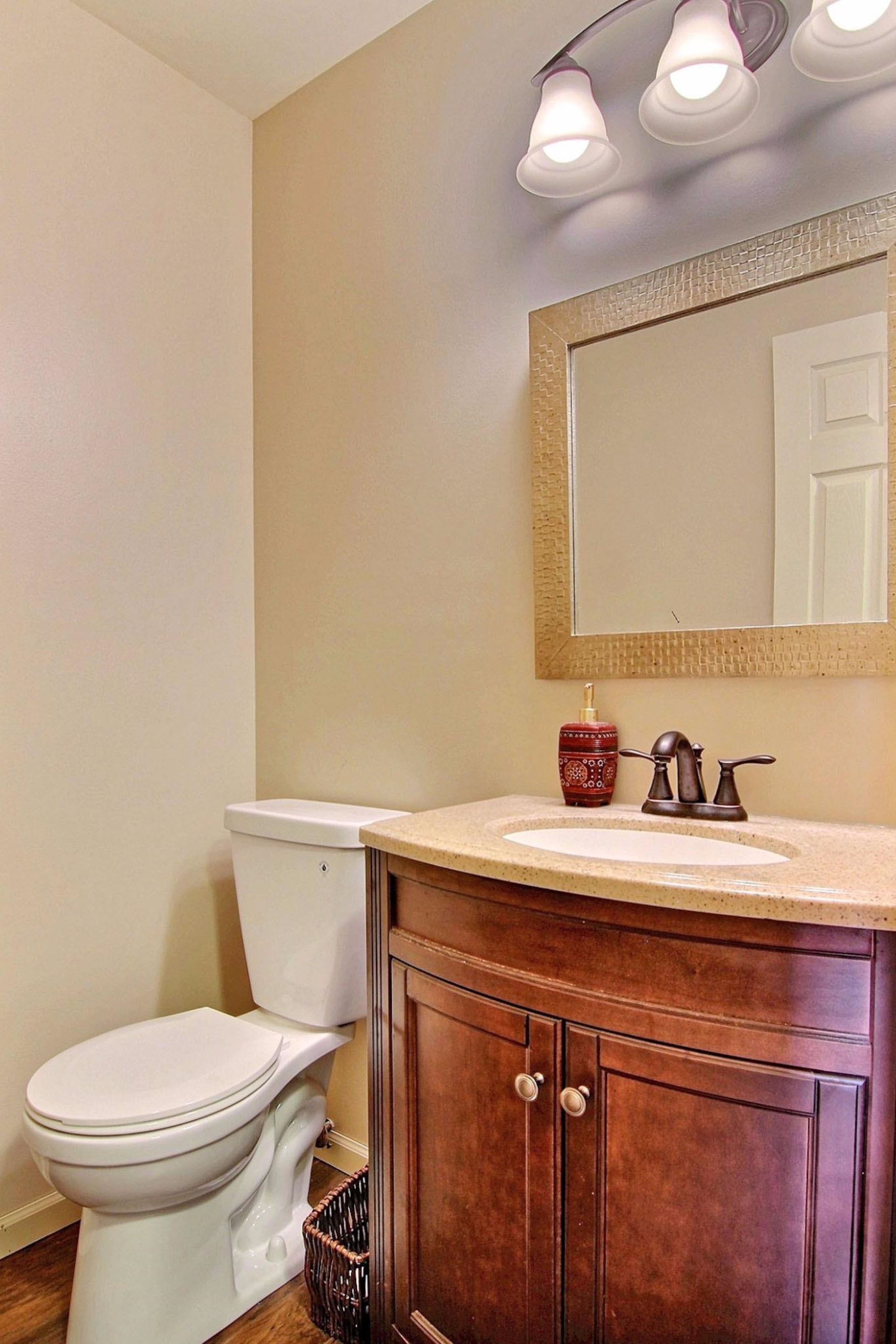2218 Coldspring Road Crown Point, IN 46307 - Photo 7 of 10 a bathroom with a sink a toilet and mirror