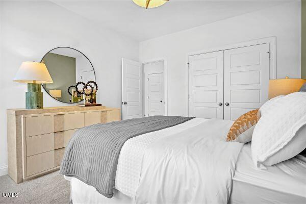 605 Hedrick Ridge Road, Unit 105 Cary, NC 27519 - Photo 24 of 34 a bedroom with a bed and a dresser