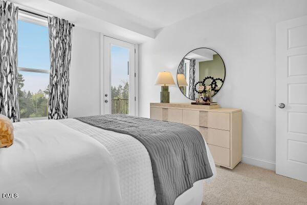 605 Hedrick Ridge Road, Unit 105 Cary, NC 27519 - Photo 25 of 34 a bedroom with a bed and a mirror