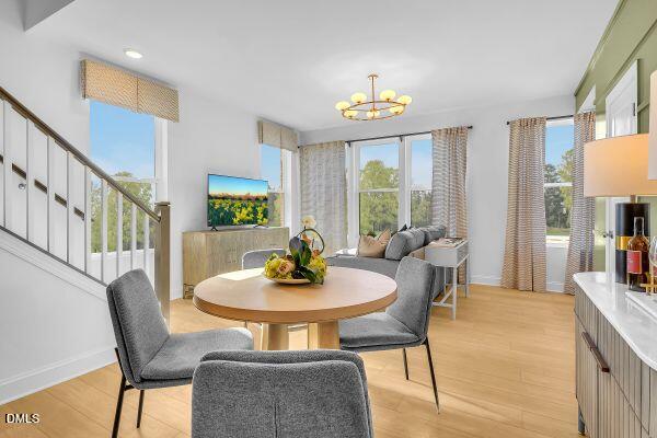 605 Hedrick Ridge Road, Unit 105 Cary, NC 27519 - Photo 4 of 34 a view of a dining room with furniture a rug and a large window