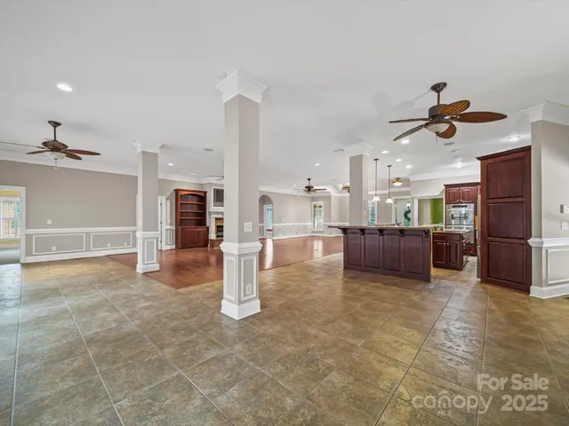 a living room with furniture and kitchen view