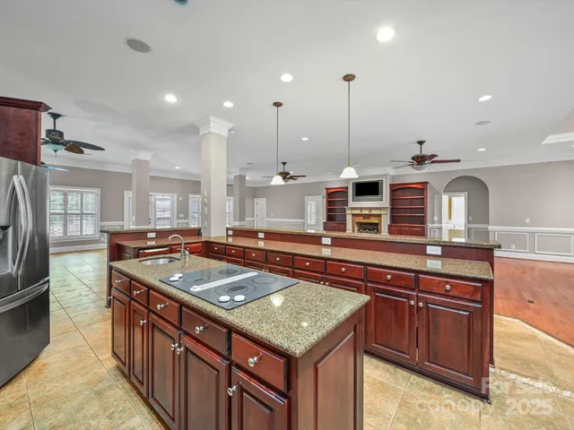 a kitchen with stainless steel appliances granite countertop a sink and a stove