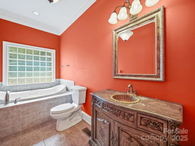 a bathroom with a granite countertop toilet a sink and a bathtub