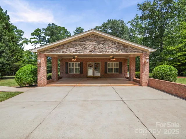 a front view of a house with yard and trees