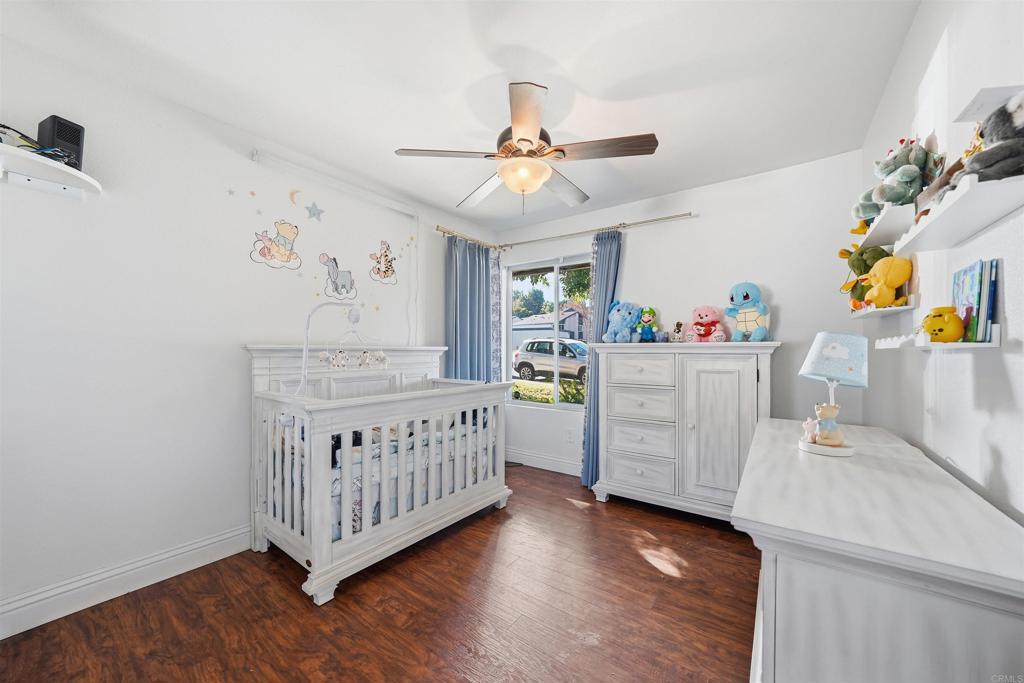 961 Jamacha Road, Unit A El Cajon, CA 92019 - Photo 8 of 14 a bedroom with a bed and wooden floor