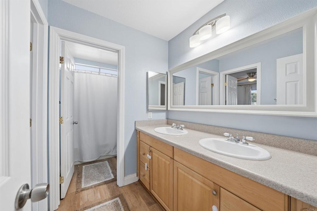 961 Jamacha Road, Unit A El Cajon, CA 92019 - Photo 9 of 14 a bathroom with a granite countertop sink and a mirror