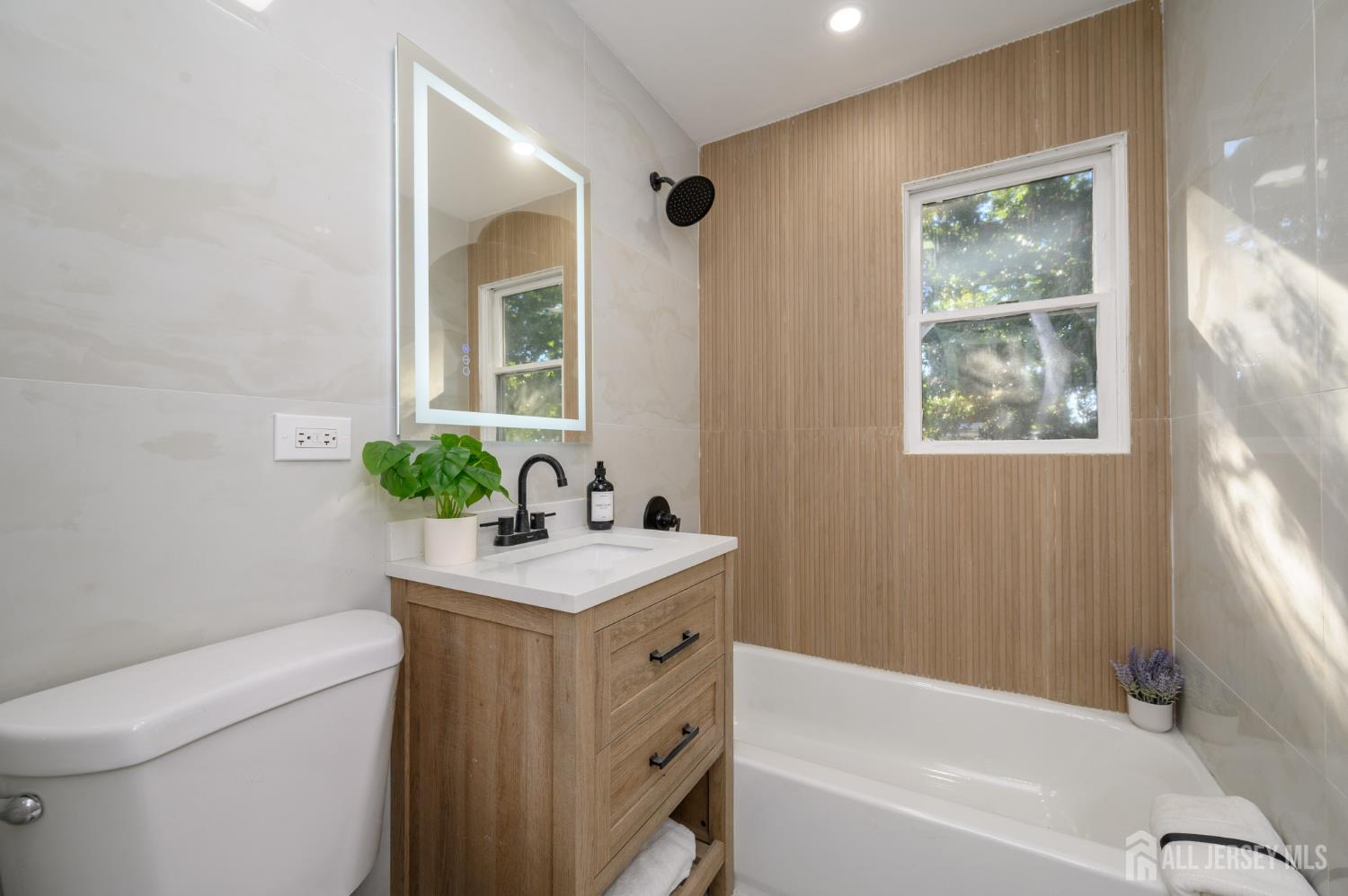 333 1st Street Middlesex, NJ 08846 - Photo 12 of 24 a bathroom with a sink a toilet and shower