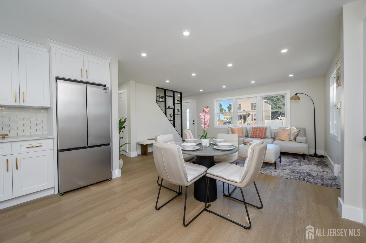 333 1st Street Middlesex, NJ 08846 - Photo 8 of 24 a living room with furniture and a refrigerator