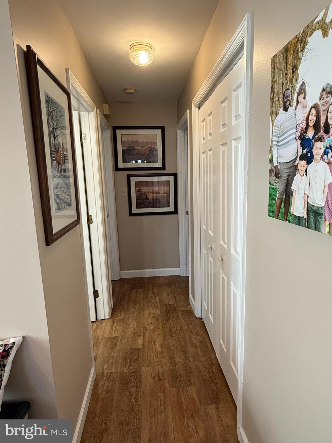 4713 Charles Road Mechanicsburg, PA 17050 - Photo 12 of 19 a view of a hallway with wooden floor and furniture