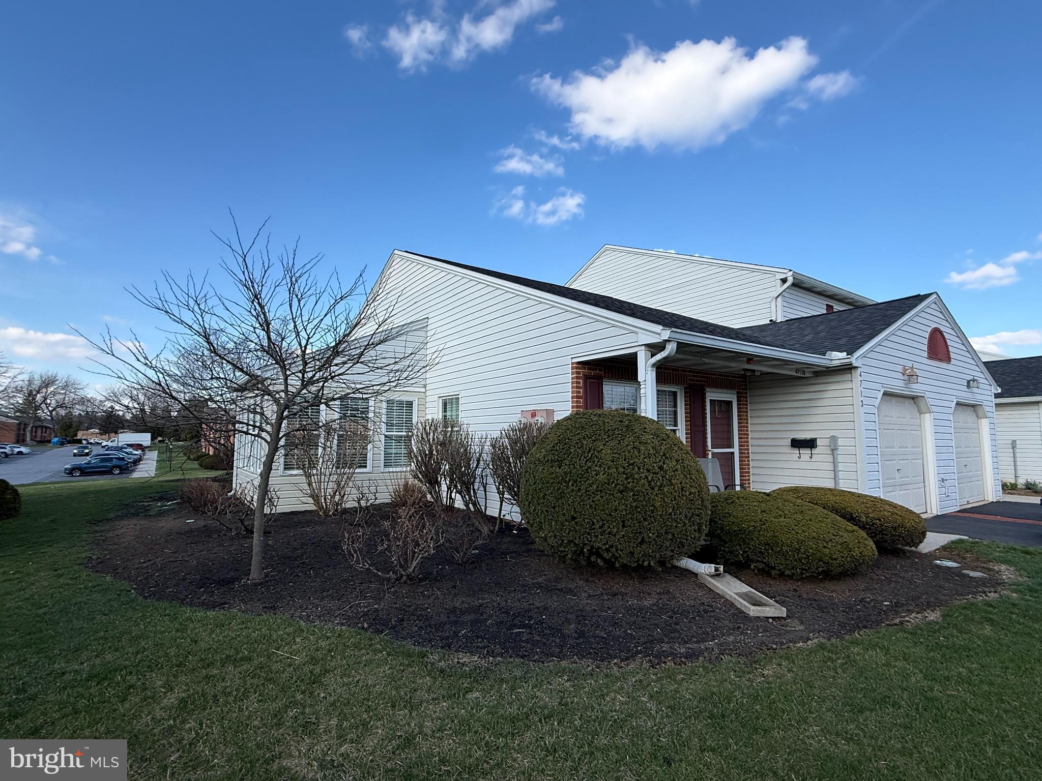 4713 Charles Road Mechanicsburg, PA 17050 - Photo 2 of 19 a view of a white house next to a yard with plants and trees