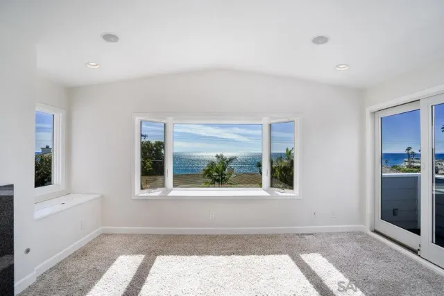 a spacious bedroom with a large bed and a couch