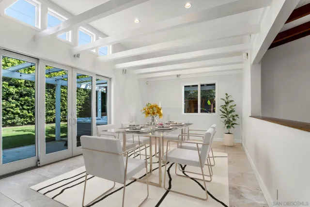 a dining room with furniture wooden floor and a potted plant