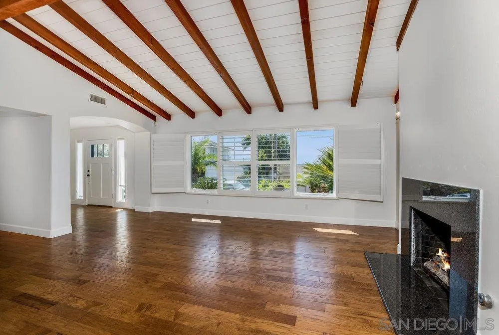 5247 Chelsea Street La Jolla, CA 92037 - Photo 10 of 29 a view of an empty room with wooden floor and a window