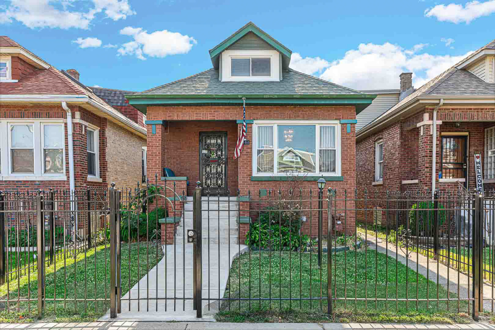7510 South Carpenter Street Chicago, IL 60620 - Photo 1 of 23 a front view of a house with a garden