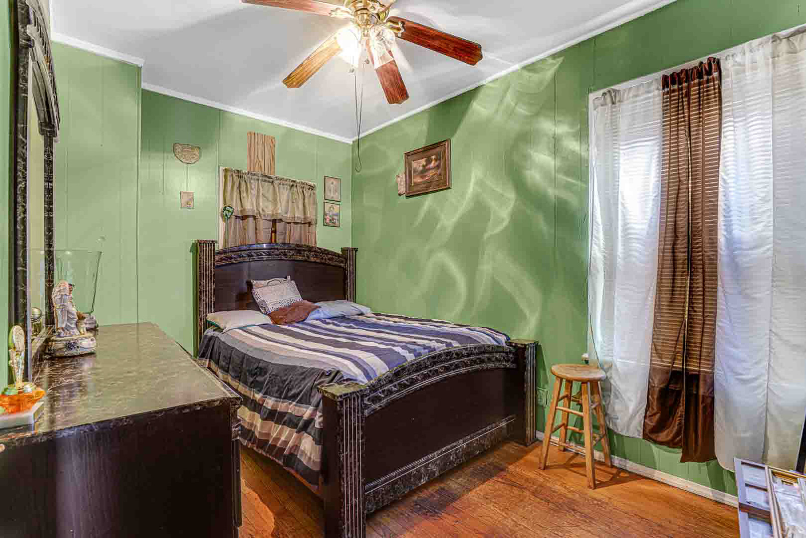 7510 South Carpenter Street Chicago, IL 60620 - Photo 9 of 23 a bedroom with a bed and a chandelier