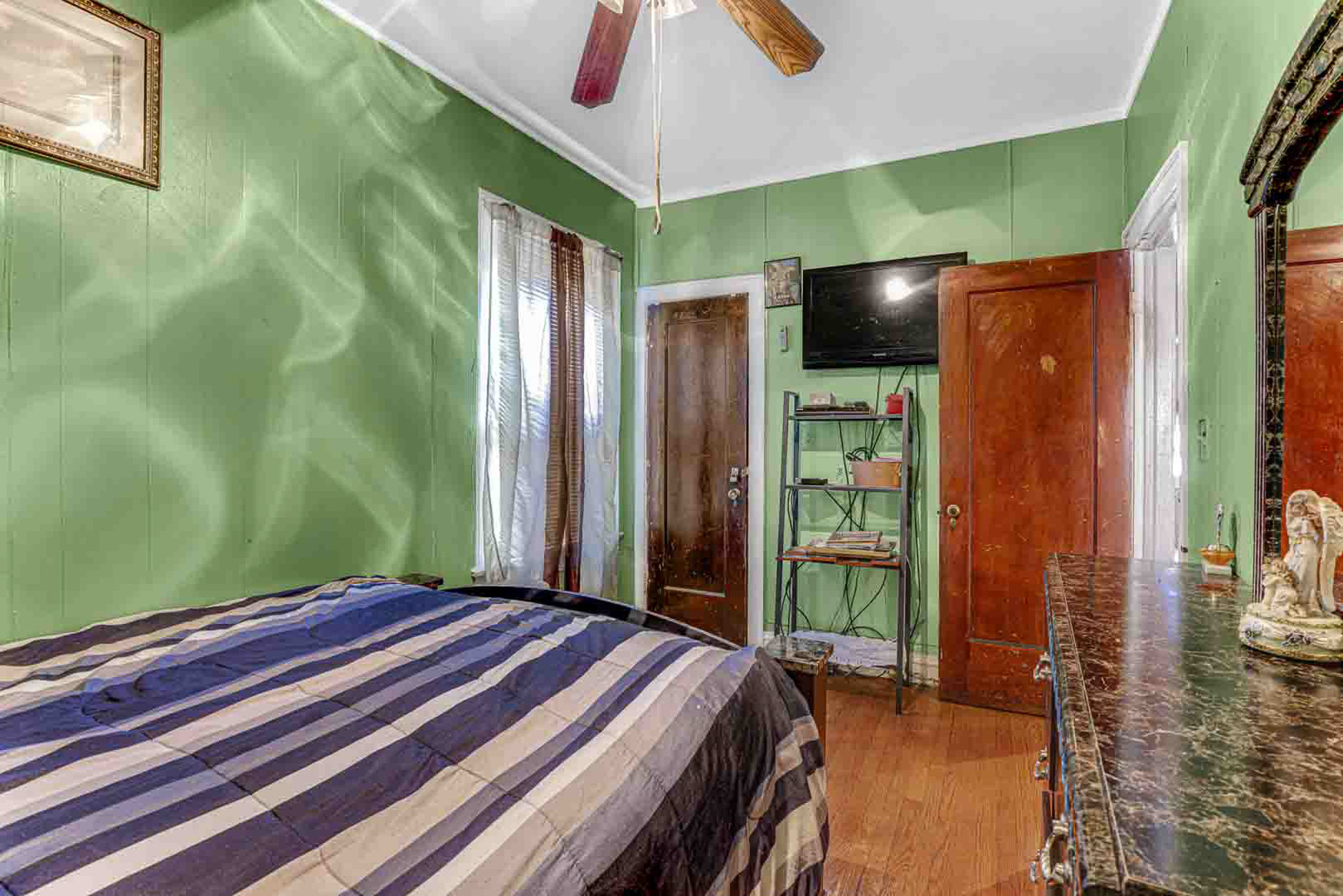 7510 South Carpenter Street Chicago, IL 60620 - Photo 10 of 23 a bedroom with a bed and a chandelier