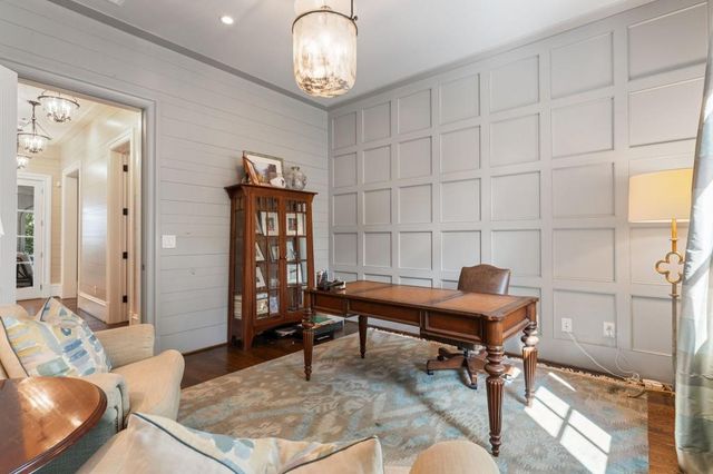 a room with wooden floors and pool table