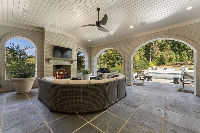 a bathroom with a granite countertop toilet sink and mirror
