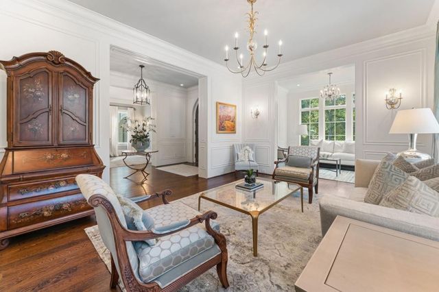 a living room with furniture fireplace and a large mirror