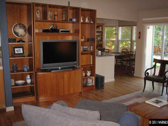 10415 Nighthawk Circle Reno, NV 89523 - Photo 12 of 13 a living room with furniture a flat screen tv and floor to ceiling window