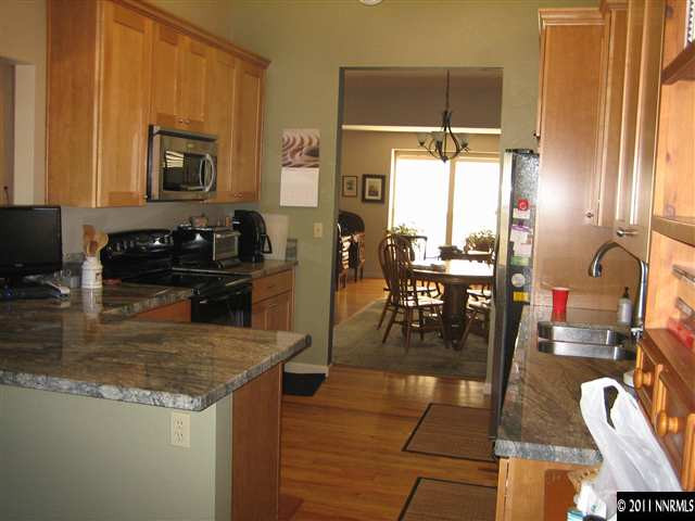 10415 Nighthawk Circle Reno, NV 89523 - Photo 8 of 13 a kitchen with a table chairs and a stove