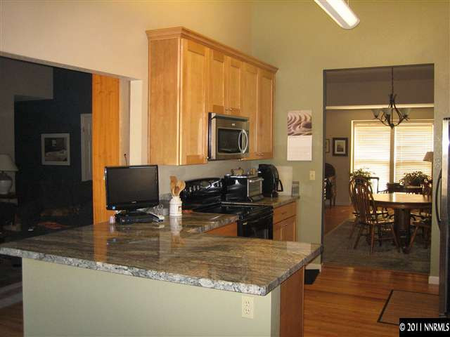 10415 Nighthawk Circle Reno, NV 89523 - Photo 9 of 13 a kitchen with a stove a sink and a refrigerator