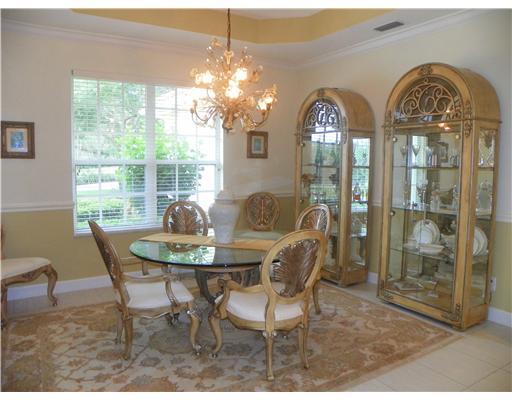 4 Castle Hill Way Stuart, FL 34996 - Photo 12 of 16 a view of a dining room with furniture wooden floor and chandelier