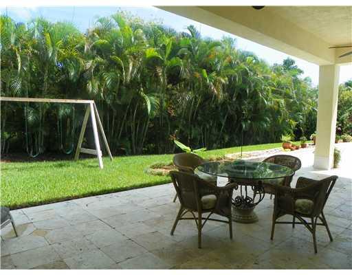 4 Castle Hill Way Stuart, FL 34996 - Photo 14 of 16 a view of yard with table and chairs