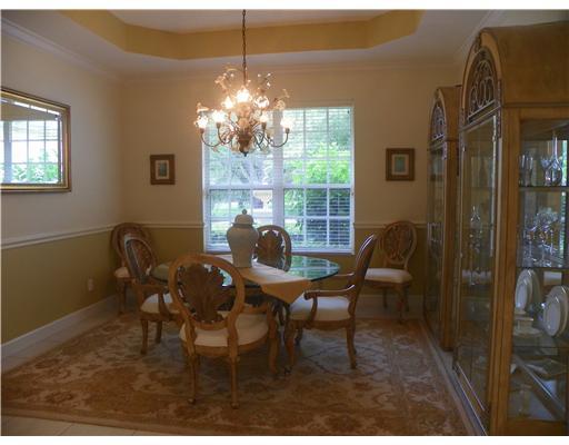4 Castle Hill Way Stuart, FL 34996 - Photo 3 of 16 a dining room with furniture a chandelier and window