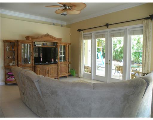 4 Castle Hill Way Stuart, FL 34996 - Photo 7 of 16 a living room with furniture and a large window