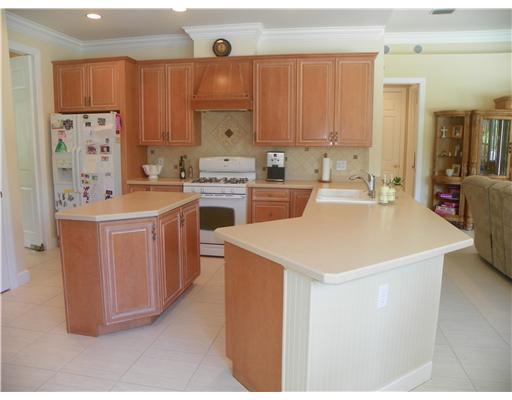 4 Castle Hill Way Stuart, FL 34996 - Photo 9 of 16 a kitchen with a sink a stove and cabinets