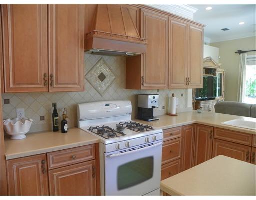4 Castle Hill Way Stuart, FL 34996 - Photo 10 of 16 a kitchen with a sink a stove and cabinets