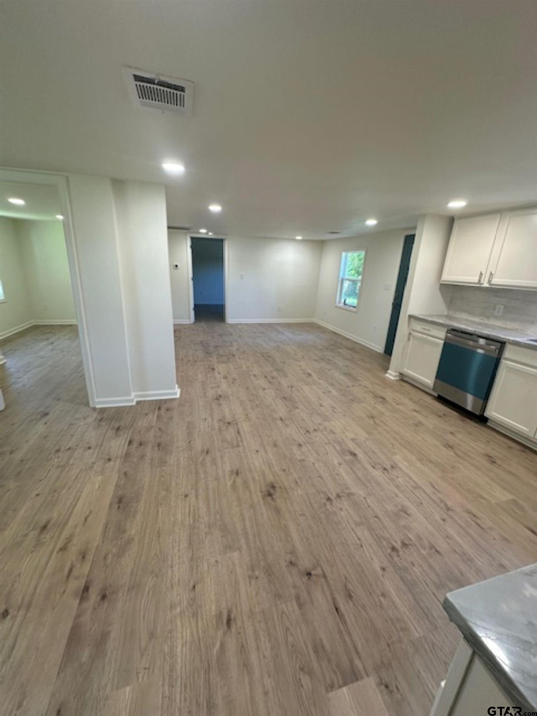 149 East Iowa Street Van, TX 75790 - Photo 16 of 17 an empty room with wooden floor and entrance