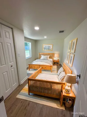 a bedroom with a bed and wooden floor