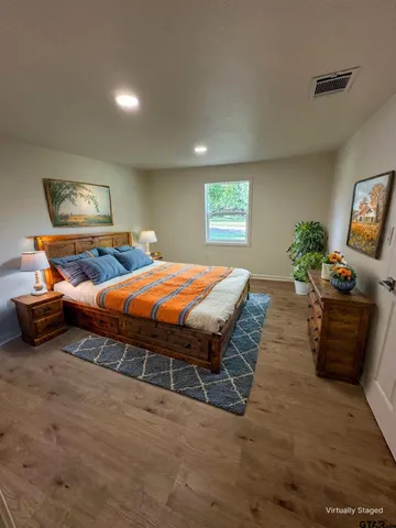 a bedroom with a bed and a couch