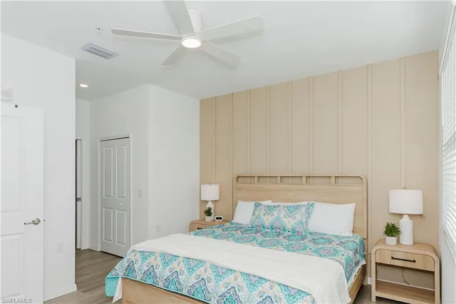 a bedroom with a bed and a lamp