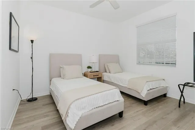 a bedroom with two beds and a couch